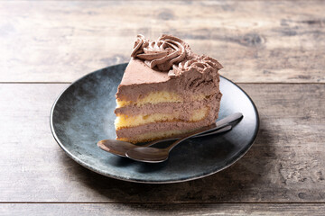 Piece of chocolate truffle cake on wooden table	