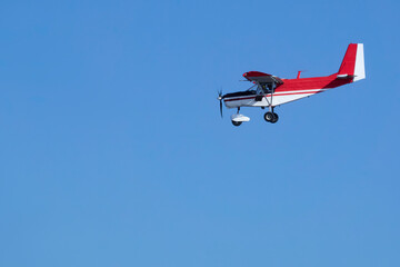  A small sports plane in flight. Copy space.           