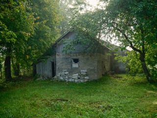 old countryside barn from wooden planks and concrete in rural area