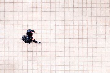 top view of a young man walking around the city