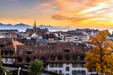 Fototapeta na wymiar Cityscape sunset of the old city of Lausanne In Switzerland. Background with views to Lake Geneva mountains.