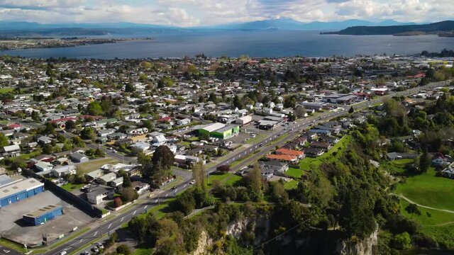 Taupo town on lakefront Lake Taupo, New Zealand aerial cityscape. Pull back reveal Waikato river