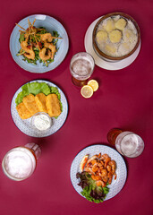 snacks and beer on a burgundy background top view. food photos.