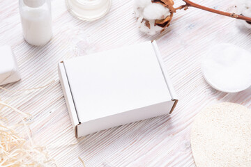 Fototapeta na wymiar White cardboard, carton boxes on wooden table, for cosmetic small business