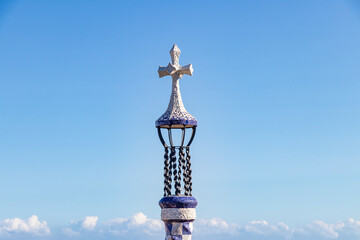 Cross in the entrance of The famous Parc Güell designed by the architect Gaudí in the city of Barcelona. - obrazy, fototapety, plakaty