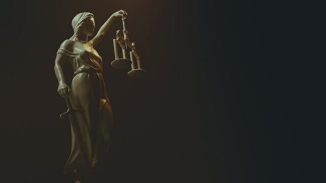Lady justice figure holding scales and a sword on a black background. Symbol of law and fair judgment.