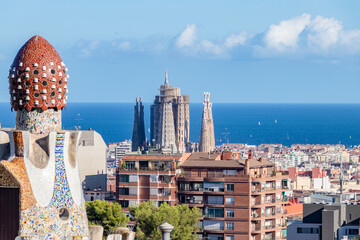 View of La Sagrada Familia of Gaudí and the Mediterranean sea from the famous Park Güell of the...