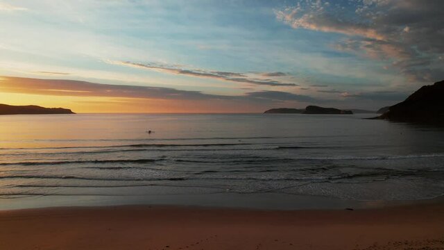 Sunrise at the seaside with clouds and gentle sea at Umina Beach on the Central Coast, NSW, Australia.