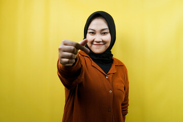 Beautiful young asian muslim woman smiling, with korean love sign hand, hand close to camera, isolated