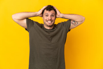 Fototapeta na wymiar Young caucasian handsome man isolated on yellow background doing nervous gesture