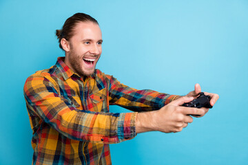 Photo of cool millennial tail hairstyle guy playstation look empty space wear plaid shirt isolated...
