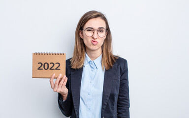 young pretty woman feeling puzzled and confused. calendar concept