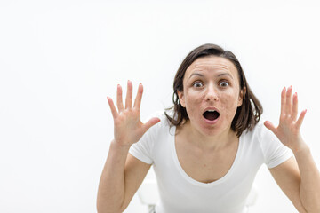 Photo of shocked woman because of her skin problems.