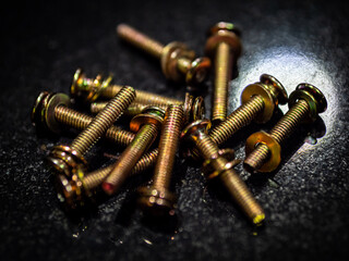Closeup shot of a handful of bolts and washers