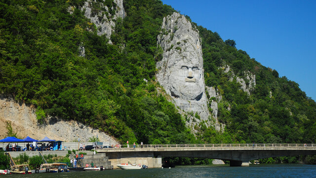 The huge stone carved statue showing the portrait of the ancient dacian king: Decebal. The sculpture is located on the shores of Danube River, Eselnita, Romania 