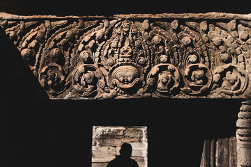 Carved lintel at the entrance in the ancient old Buddhist temple of Angkor wat in Cambodia