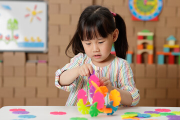 young irl playing creative toy blocks at home