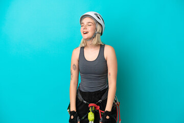 Young caucasian rock-climber woman isolated on white background laughing in lateral position