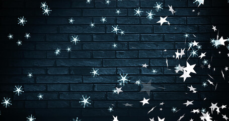 Image of christmas snowflakes and stars falling over black brick background