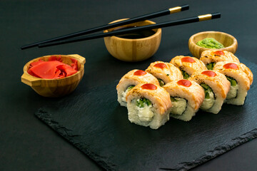 Grilled Philadelphia roll sushi with salmon, prawn, avocado, cream cheese. Sushi menu. Japanese food.