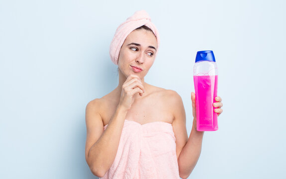young pretty woman thinking, feeling doubtful and confused. shower and shapoo concept