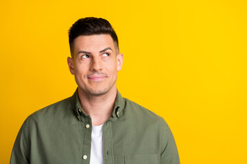 Portrait of attractive bewildered guy overthinking making solution copy space isolated over bright yellow color background