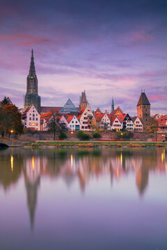 Ulm, Germany. Cityscape image of old town Ulm, Germany with the Ulm Minster, tallest church in the world and reflection of the city in Danube River at autumn sunset.