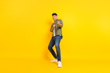Fototapeta na wymiar Full body photo of young guy happy positive smile point fingers you choice select isolated over yellow color background