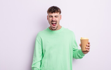 young handsome man shouting aggressively, looking very angry. take away coffee concept
