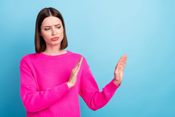 Portrait of attractive dissatisfied girl showing stop sign aside isolated over bright blue color...