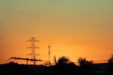 
antenna transmission line at sunset silhouette of tower