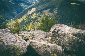 View from the top of the mountain.Large rocky stones. Beautiful landscape from mountains to forest. Beautiful nature. Large stones in the close-up. Rocky mountains and a huge forest.