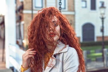 Redhead curly woman in the city