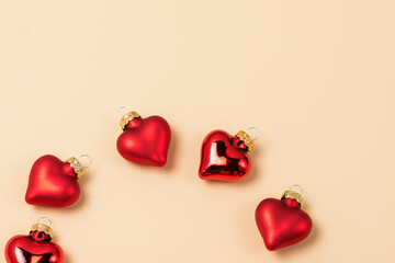 Christmas Ornaments in Shape of Hearts Red Decoration Ball Christmas or St.Valentine Background or Card Yellow Background Horizontal