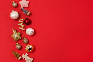 Festive Christmas Background or Card Red and Gold Holiday Decorations and Confetti on Red Background Top View Horizontal Copy Space