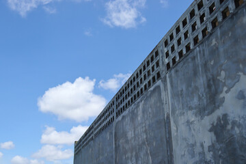 The high wall fence line is made of cement