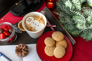 christmas, winter holidays and leisure concept - close up of marshmallow snowman in cup of coffee