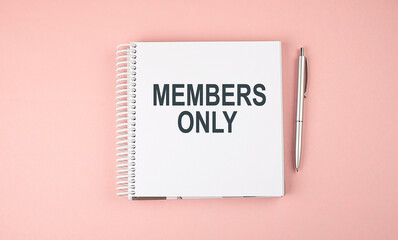 MEMBERS ONLY text on notebook with pen on the pink background