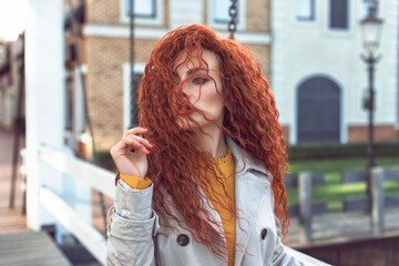 Redhead curly woman in the city