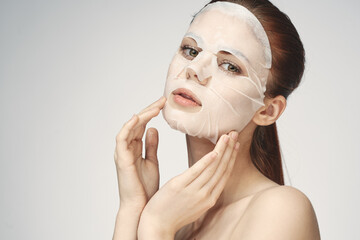 emotional woman cosmetic face mask close-up light background