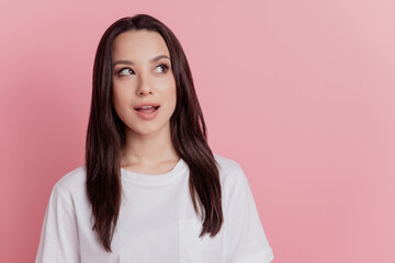 Fototapeta premium Photo of young excited girl amazed shock surprised wondered look empty space isolated over pink color background