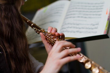 A young lady practicing a flute