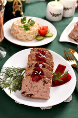 Cranberry pate and other traditional Christmas Eve dishes on festive table