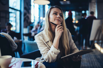 Young student doing homework in cafe