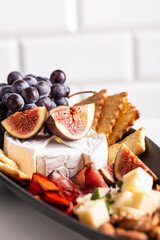 Assorted cheese, prosciutto, nuts, snacks and fruits