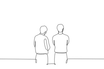 two men are standing with their arms crossed and looking at something above eye level - one line drawing vector. concept of exhibition visitors, passers-by stopped to look, observers or waiting