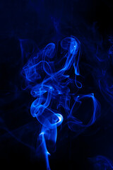 Fototapeta premium Movement blue smoke on black background.