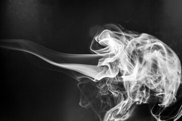 White  smoke motion on black background.