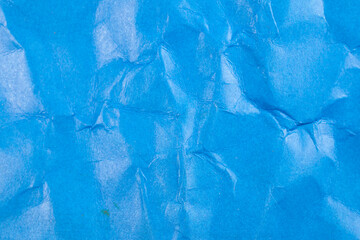 Crumpled blue paper background.