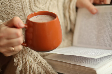 person reading book with coffee